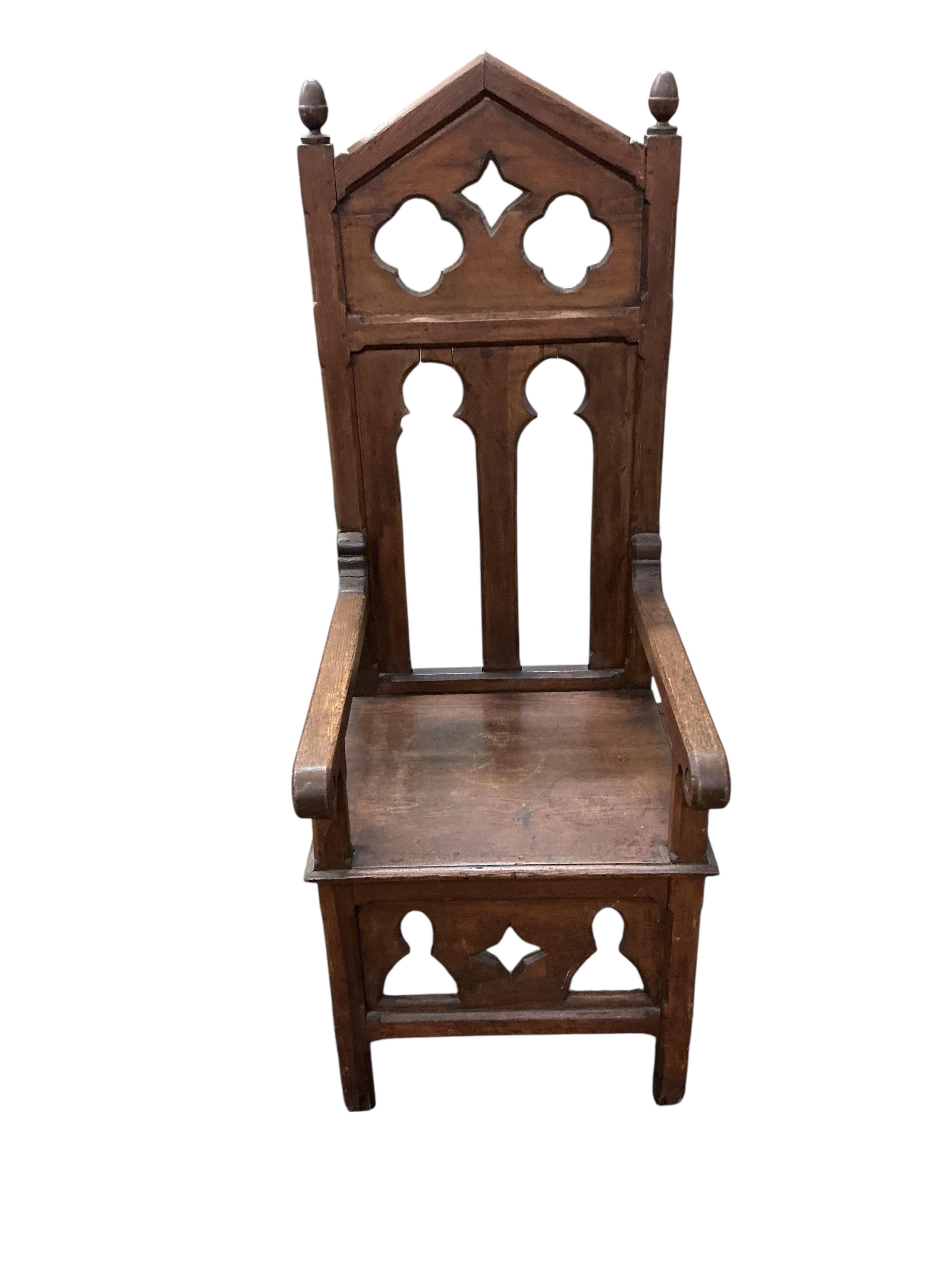 A pair of Gothic style ecclesiastical pine high back elbow chairs, width 52cm, depth 60cm, height 143cm
